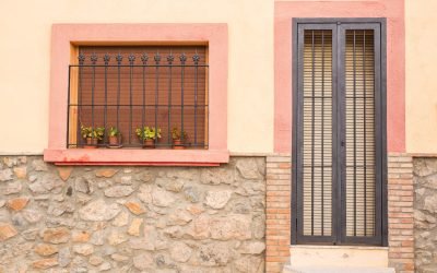 Design, architecture and exterior concept - Small window and door with lattice on the white facade.