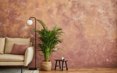 Stylish living room interior composition with modern beige sofa, plant and personal accessories. Creative wallpaper. Home staging. Template. Copy space.